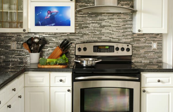 A kitchen cabinet TV installed in a modern kitchen