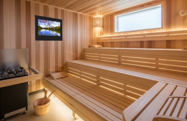 a large, bright sauna with a sauna TV installed