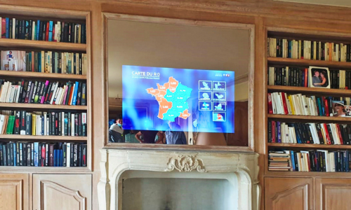 A custom magic mirror TV over a fireplace